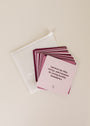 Boundaries Shower Affirmations™—a set of pink waterproof cards—is spread out beside a translucent zip pouch. The top card says, "I protect my time, energy, and emotions by setting healthy boundaries.
