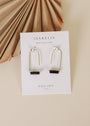 The Black Onyx Gemstone Drop - Focus earrings are gold plated drops with black onyx, presented on a JaxKelly card against a neutral background and dried palm leaf decor.