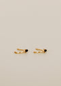 The Open Mini Hoop Earring - Black features delicate gold-plated hoops adorned with small black CZ stones, shown on a plain light beige background.