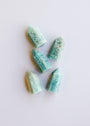 Five Mini Amazonite Quartz Crystal Points with hexagonal shapes and greenish-blue hues are arranged on a white background, each gemstone tapering to a calming stone tip.