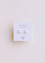 The White Opal Mini Energy Gems - Joy are small, triangular stud earrings with lab-grown white opal and 18k gold plating, shown on a white JaxKelly card that reads WEAR GOOD VIBES and OPAL joy, set against a light, neutral background.