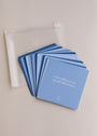 Sobriety Shower Affirmations™—blue waterproof affirmation cards beside a clear pouch, ideal for your recovery journey. The top card says, “I am willing to see myself differently.”.