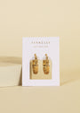 Textured Hoop - Earring with 18k gold plating, shown on a white JaxKelly card featuring "Wear Good Vibes" below the brand name, set against a light beige background.