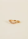 The Ring - Pave Wave - Champagne CZ features 18k gold plating and a curved band set with sparkling champagne cubic zirconia, shown against a plain, light background.