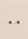 The Malachite Sun Stud features 18k gold-plated sun-shaped earrings with a small round malachite stone at the center, shown on a plain beige background.
