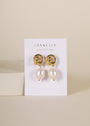 The Pearl Knot - Earring features 18k gold plated knot studs with dangling freshwater pearls, displayed on a JaxKelly card against a neutral background.