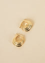 Triple Arch Hoop - Earring: Gold hoop earrings featuring a layered, wavy triple-arch design, shown on a light beige background. These retro-modern hoops elevate any look with their unique style.