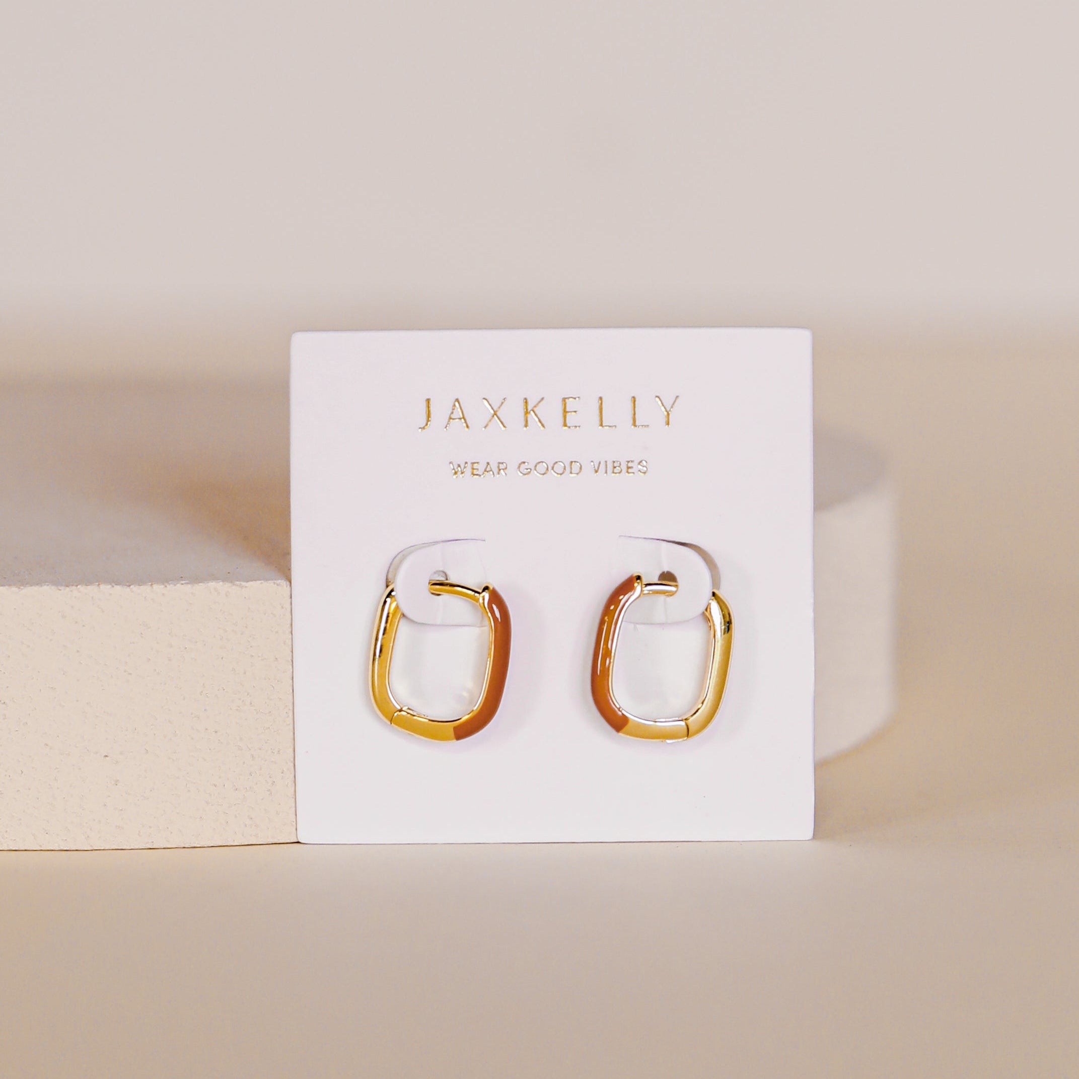 A pair of brown Color Dipped Rectangle Hoop Earrings with sterling silver posts displayed on a white JaxKelly card that reads WEAR GOOD VIBES, set against a neutral, minimal background.