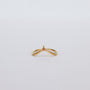The Arched Triangle Ring - Champagne features a delicate 18k gold band with a small, champagne-colored pear-shaped gemstone at the center, set against a plain white background for an elegant, heirloom-inspired look.