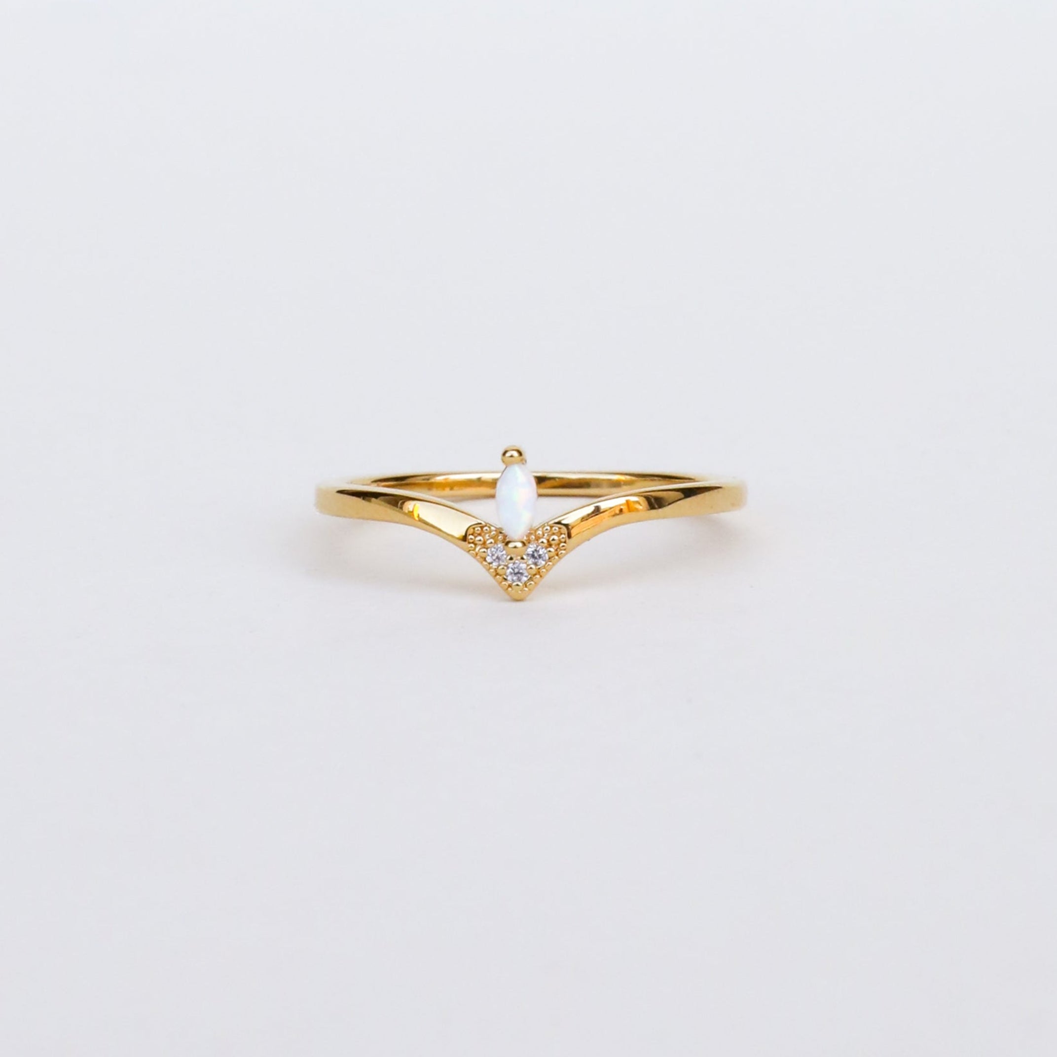 The Floating Gemstone Ring - White Opal features a delicate 18kt gold V-shaped band adorned with sparkling stones and a shimmering white opal, displayed on a plain white background.