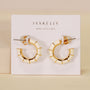 A pair of Vintage Hoop Earrings - Cream Enamel with a gold and cream segmented, geometric design is displayed on a white card featuring JAX KELLY and WEAR GOOD VIBES.