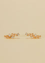 The Cascading Baguette Drop - Gold Earrings feature a delicate, branch-inspired design with sparkling CZ stones and gold plating, shown against a neutral beige background.
