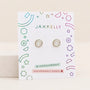 Volleyball Enamel Flat Back Kids Earrings featuring a volleyball design with black lines on a branded JaxKelly display card.