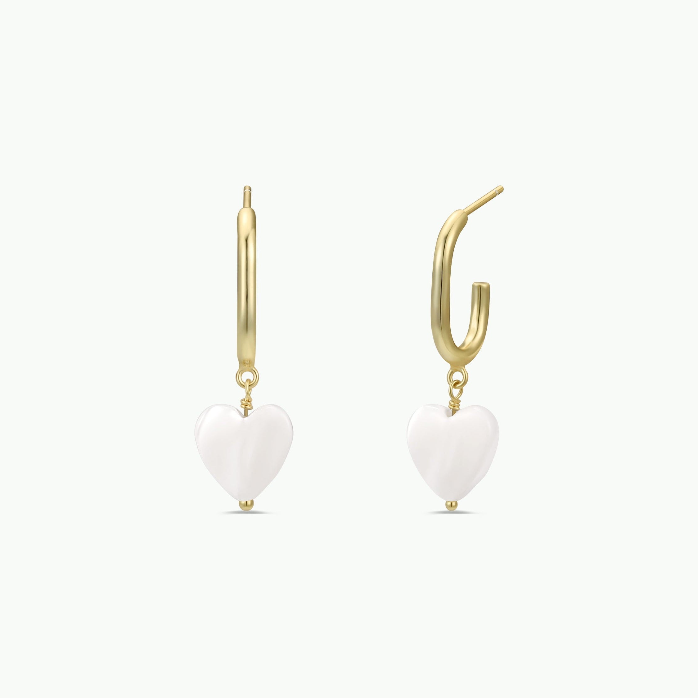 A pair of tarnish-free gold hoop earrings featuring dangling mother of pearl heart charms, displayed on a plain white background. Product Name: Heart Drop - Mother of Pearl.