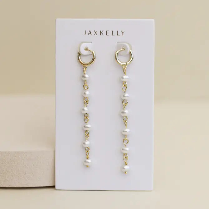 Multi Pearl Drop earrings by JaxKelly: 18k gold plated hoops with dangling chains and small white pearls, displayed on a white JaxKelly card against a light beige background—ideal for elegant pearl drop earring lovers.
