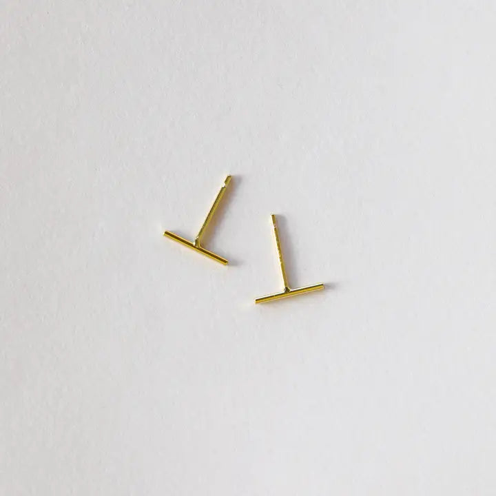 The JaxKelly Minimalist Bar earrings, shown at slight angles on a white background, feature a sleek gold design. Hypoallergenic and modern, they're ideal for daily wear.