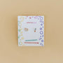 The Artist Palette Enamel Flat Back Kids Earrings, shaped like a palette and brush, are displayed on a JaxKelly card with colorful doodles and "Hypoallergenic" and "Kid-Friendly Posts" labels—ideal for sensitive ears.