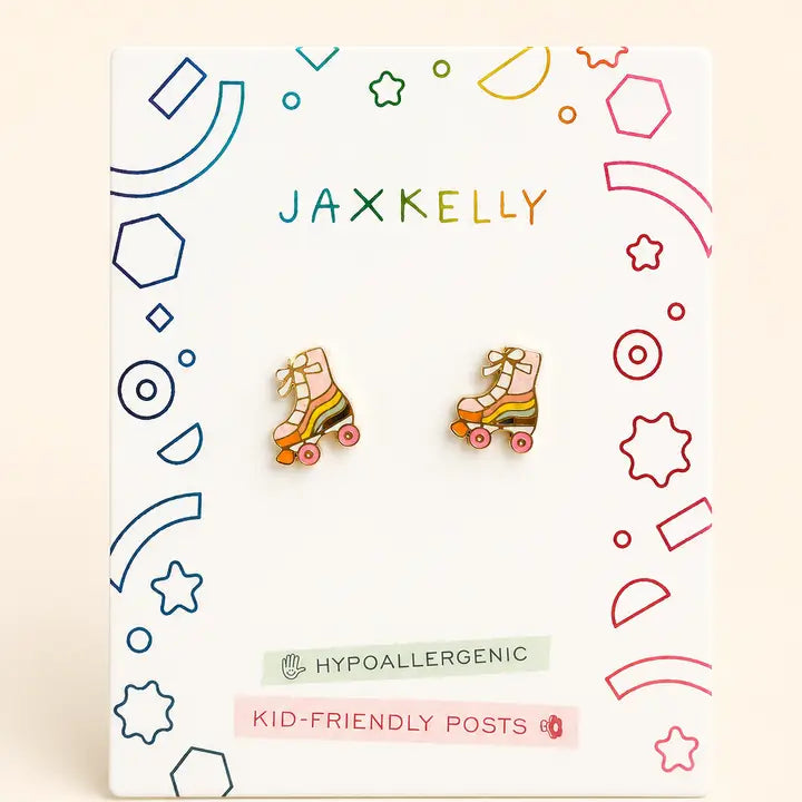 A pair of JaxKelly Roller Skate Enamel Flat Back Kids Earrings, featuring rainbow details, are shown on a white card decorated with colorful geometric and star motifs. The packaging is labeled “JaxKelly,” “Hypoallergenic,” and “Kid-Friendly Posts.” Crafted with surgical-grade stainless steel, these kids earrings offer safe and hypoallergenic wear.