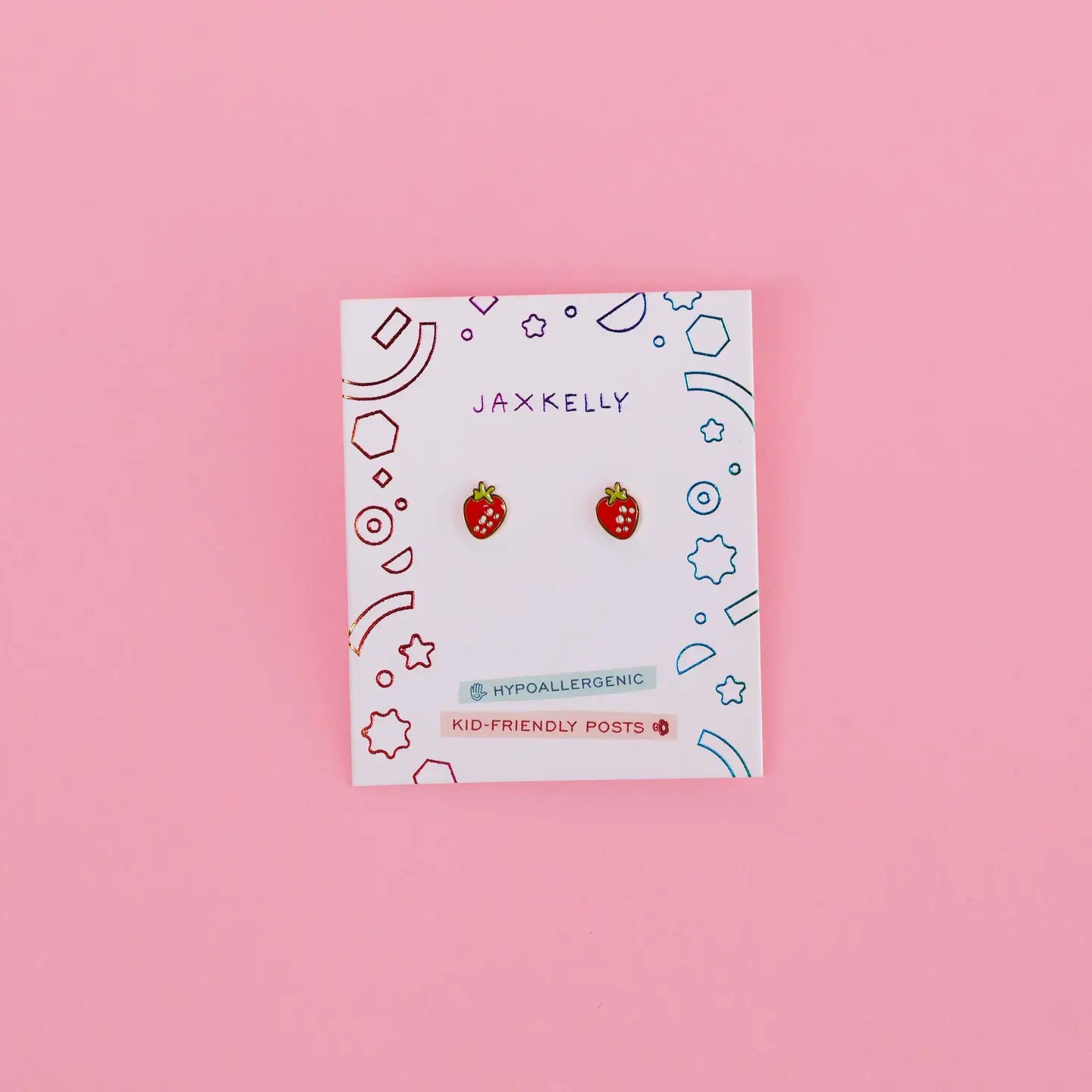 Strawberry Enamel Flat Back Kids Earrings—small, hypoallergenic, kid-friendly posts for sensitive ears—displayed on a decorative JaxKelly card against a pink background.