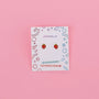 Strawberry Enamel Flat Back Kids Earrings—small, hypoallergenic, kid-friendly posts for sensitive ears—displayed on a decorative JaxKelly card against a pink background.