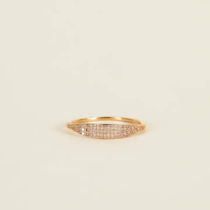The Gold Ring - Tapered Pave - Champagne CZ features a slim 18k gold-plated band and a tapered section set with sparkling champagne cubic zirconia, shown on a simple light beige background.