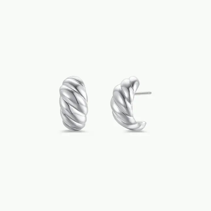 The JaxKelly Silver Swirl Hoop earrings feature a sterling silver twist design, shown on a simple white background.