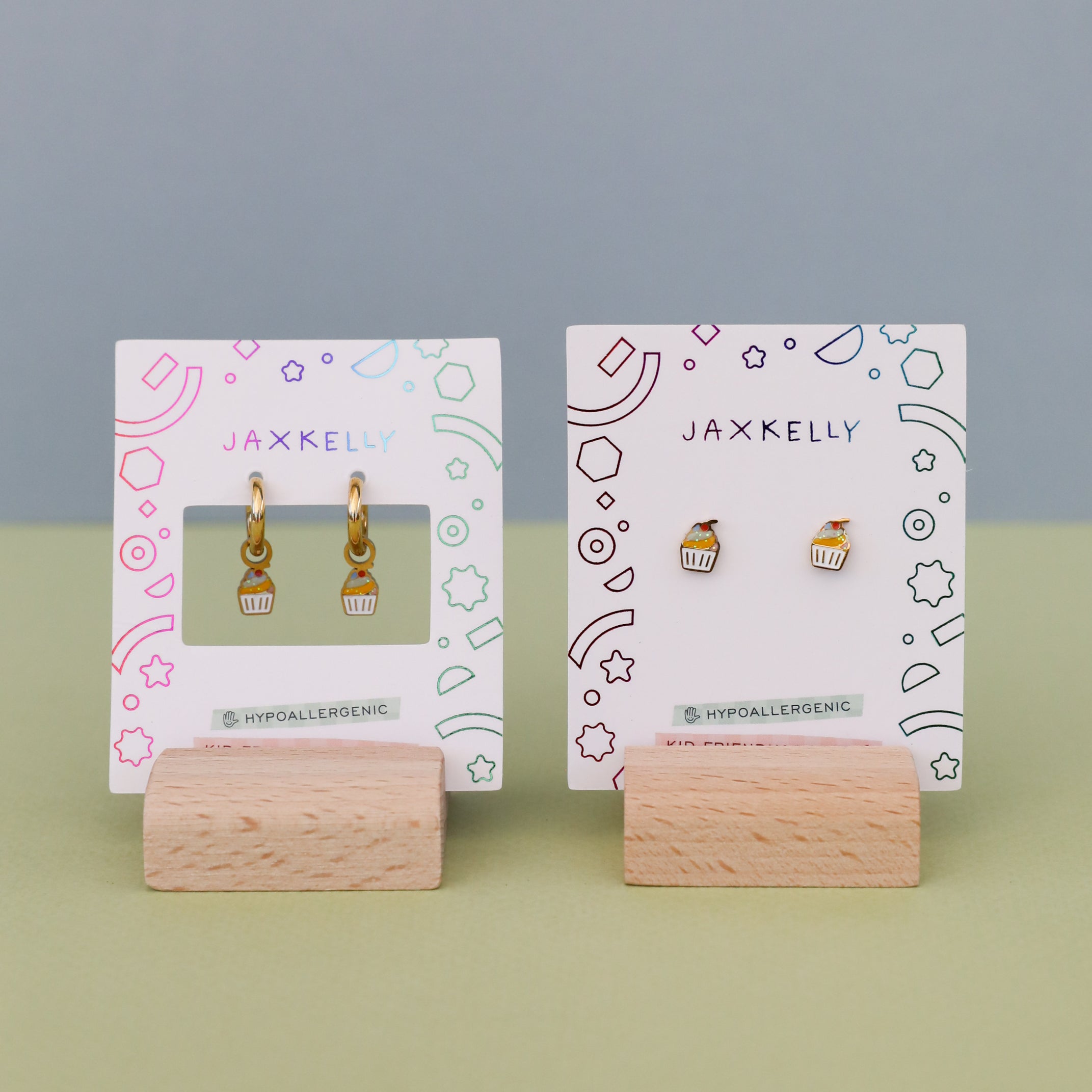 Kids earrings displayed on JaxKelly cards with playful background