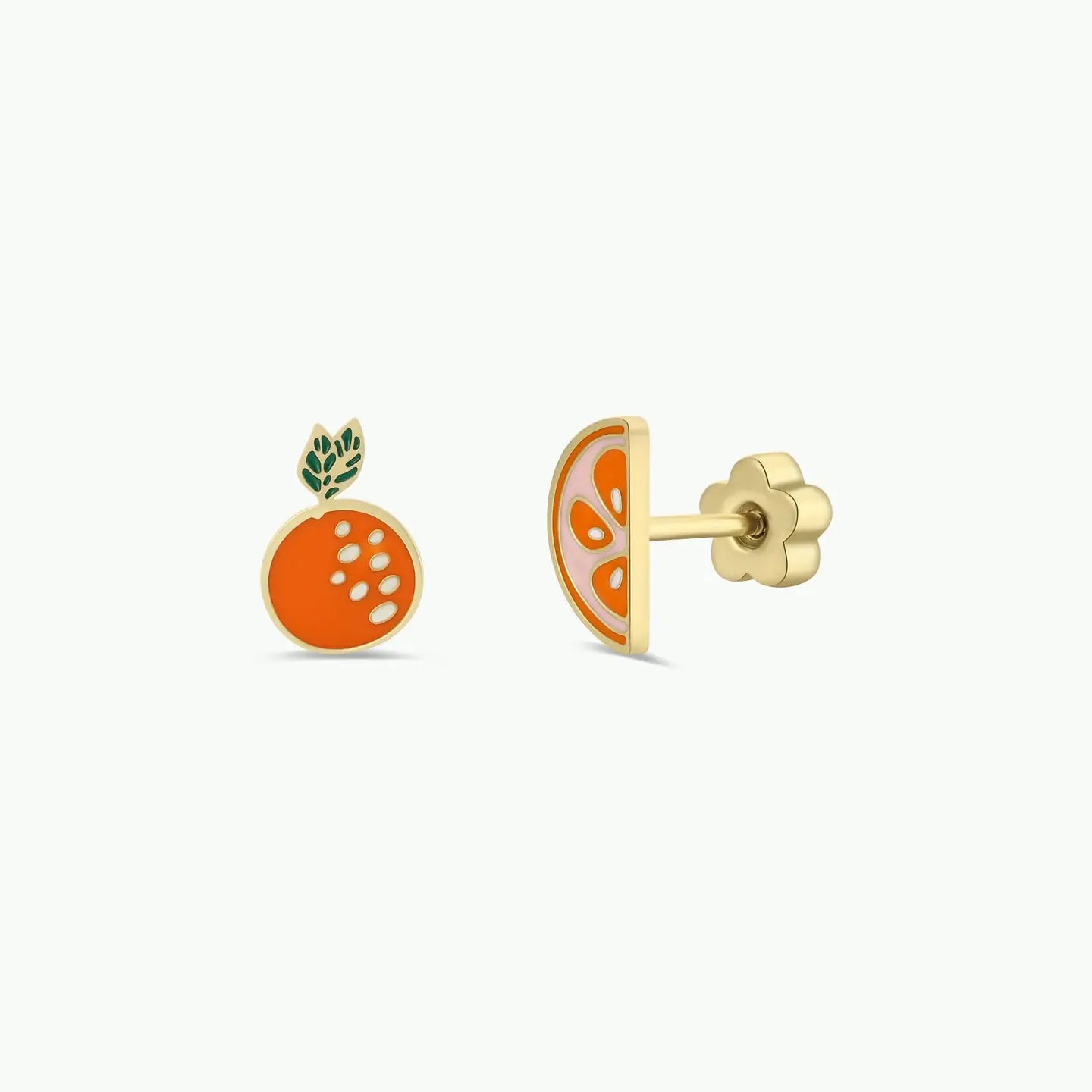 The Orange Enamel Flat Back Kids Earrings feature hypoallergenic gold studs—one shaped like a whole orange with green leaves and the other as an orange slice, both with vibrant orange enamel. Perfect for sensitive ears.