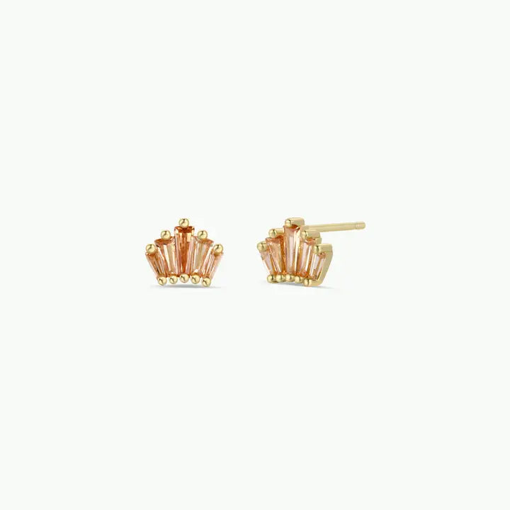 The JaxKelly Champagne Baguette Crown Earrings are tarnish-free, 18K gold plated studs set with five pink baguette-cut stones in a fan shape, shown on a light background.