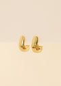 The Bold Drop Earring features small, chunky statement hoops with sterling silver posts, shown on a neutral cream background.