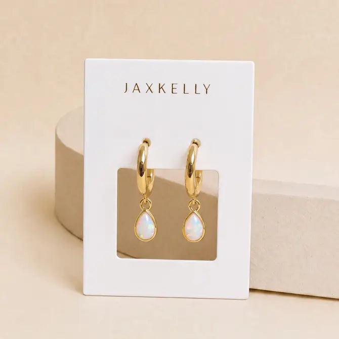 JaxKelly Teardrop Charm Hoop - White Opal earrings on a branded display card.