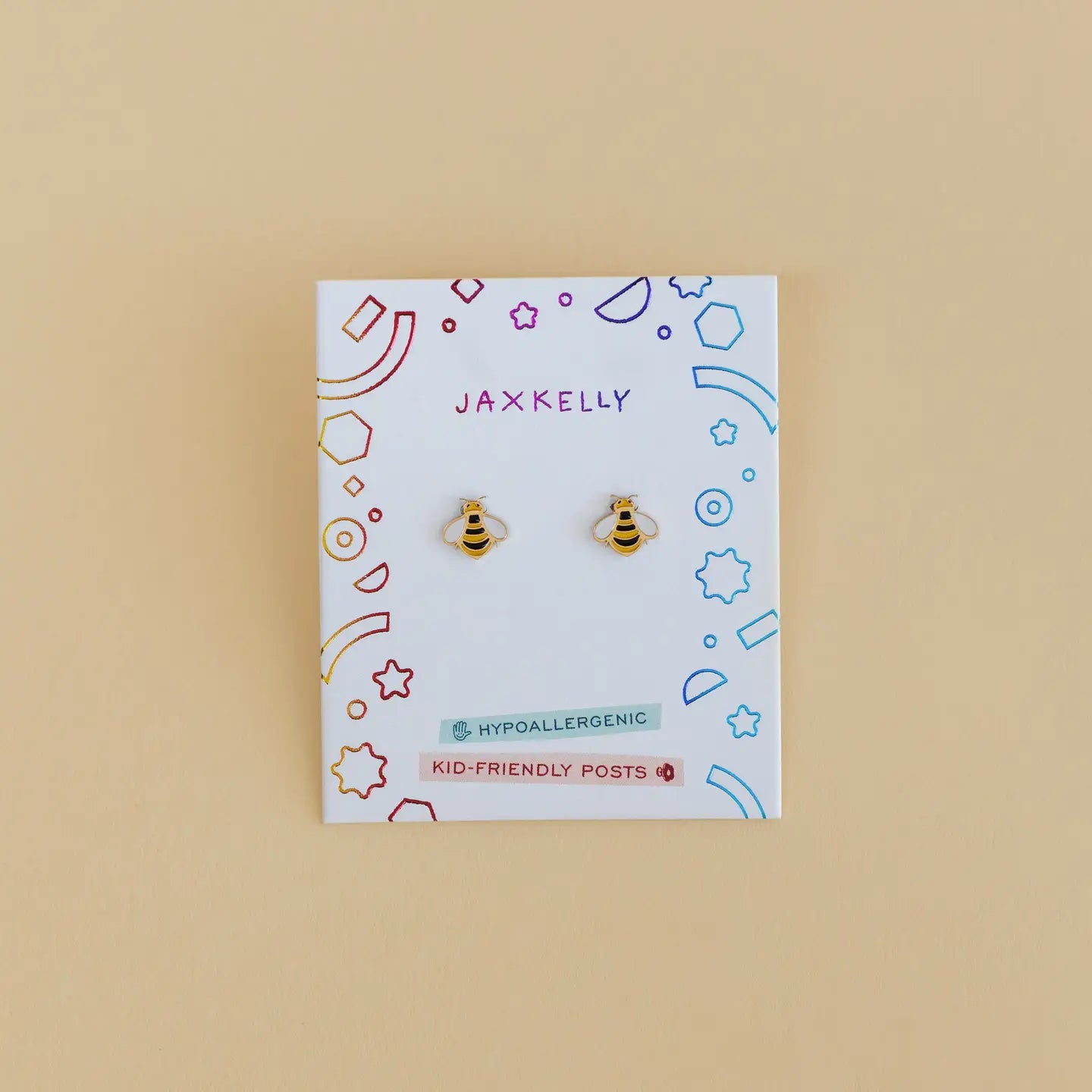 Bumble Bee Enamel Flat Back Kids Earrings on a colorful JaxKelly card labeled Hypoallergenic & Kid-Friendly Posts—perfect for sensitive ears, displayed against a beige background.