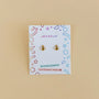 Bumble Bee Enamel Flat Back Kids Earrings on a colorful JaxKelly card labeled Hypoallergenic & Kid-Friendly Posts—perfect for sensitive ears, displayed against a beige background.