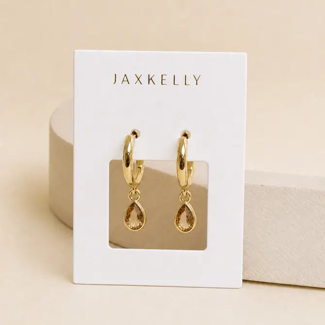 Teardrop Charm Hoop - Champagne CZ earrings by JaxKelly on a branded display card.