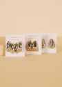 The Silver Bold Swirl - Earring set features three pairs of sterling silver-toned hoop earrings with bold, chunky, and textured designs, displayed on JaxKelly cards against a beige background.