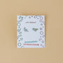 The Dinosaur Enamel Flat Back Kids Earrings feature blue and green dinosaur designs on a Jax Kelly card. The playful beige card notes "Hypoallergenic Earrings" and "Kid-Friendly Posts," making them ideal for sensitive ears.
