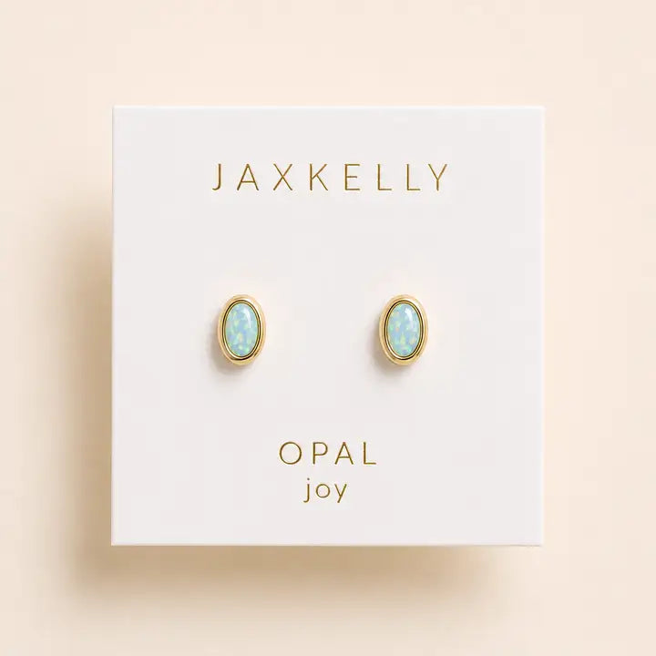JaxKelly Oval Bezel - Fire Opal stud earrings featuring oval, bezel-set light blue stones mounted on a white display card.