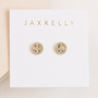 The Pavé Peace Sign earrings by JaxKelly feature sparkling CZ stones and 18k gold plating, displayed on a white card with the JaxKelly logo in gold lettering.