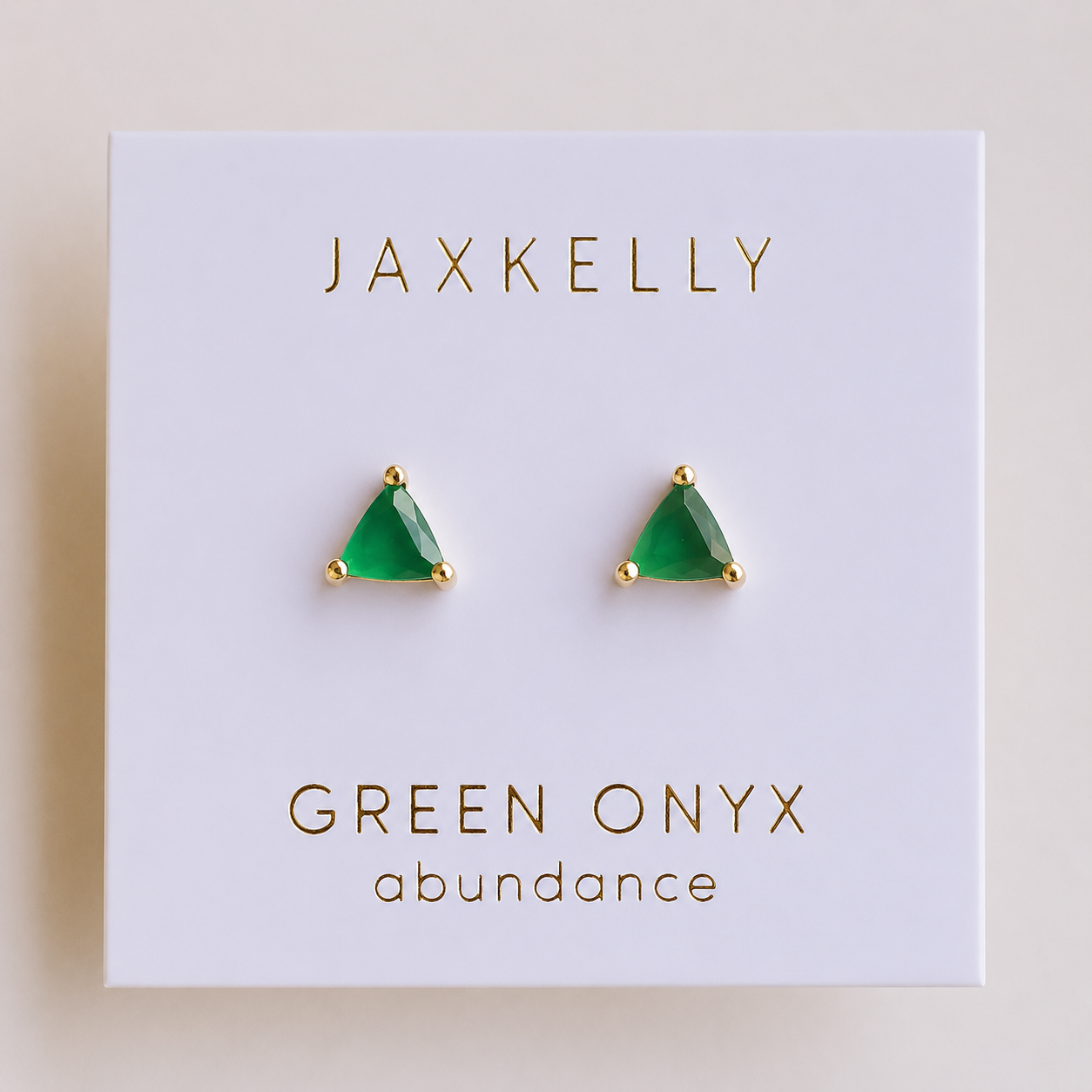 JaxKelly Green Onyx Mini Energy Gems - Abundance are triangular stone earrings set in 18k gold plating, presented on a white card with gold "JaxKelly" and "Green Onyx abundance" lettering.