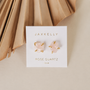 Rose Quartz Gemstone Prong - Love stud earrings by vendor-unknown with gold plated prongs, displayed on a white “JaxKelly Rose Quartz love” card, set against a neutral background with folded paper accent.