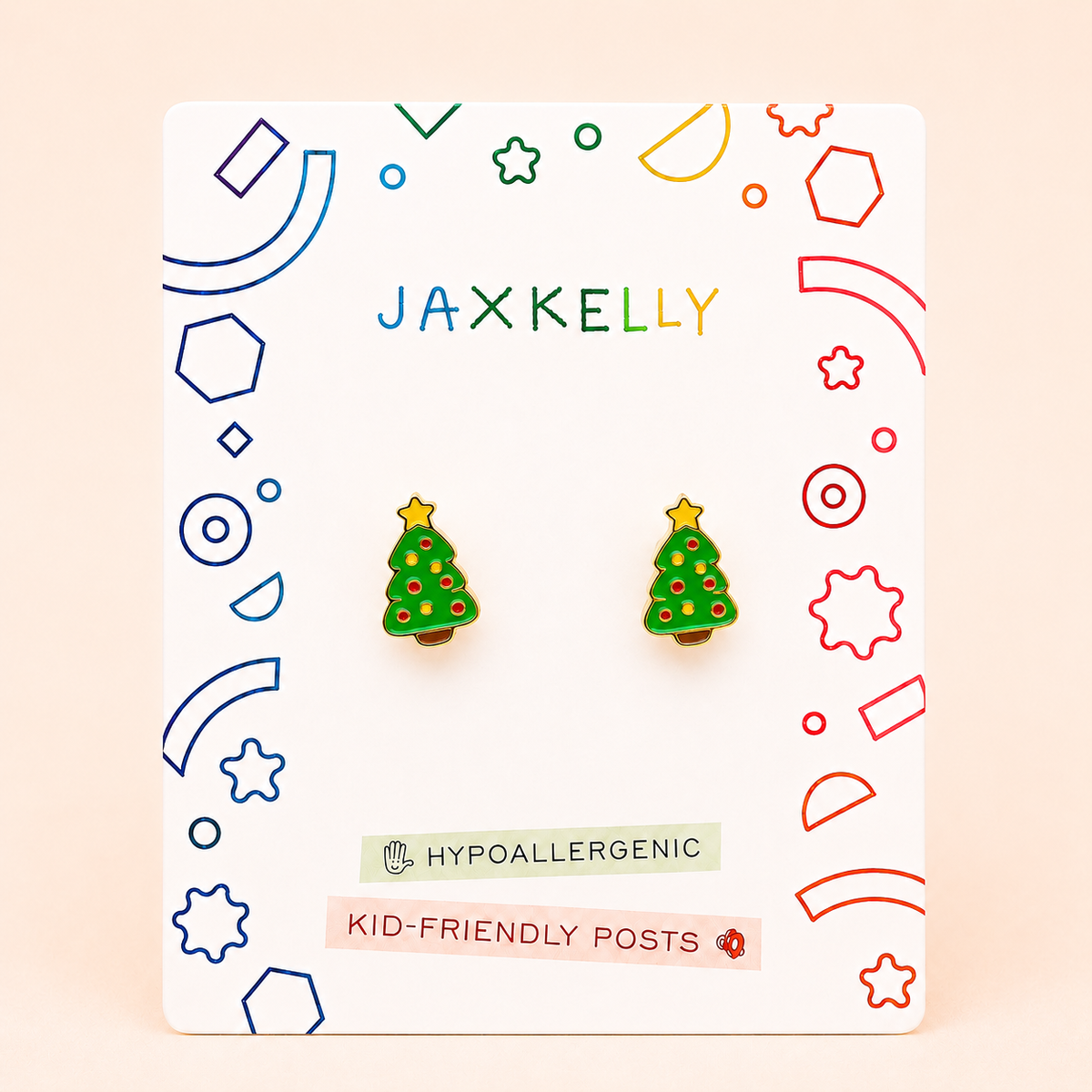 A pair of JaxKelly Christmas Tree Enamel Flat Back Kids Earrings, featuring yellow stars on top, are displayed on a vibrant card labeled Hypoallergenic and Kid-Friendly Posts. These adorable earrings are perfect for children with sensitive ears, providing both style and comfort for little ones.