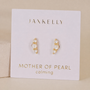 A pair of Crescent Gold Earrings - Pearl by JaxKelly on a white card reading "Mother of Pearl" and "calming" in gold. Each features small, vertically aligned pearls with comfortable sterling silver posts.