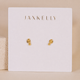 The JaxKelly Petite 3 Ball Stud earrings feature a small, gold cluster design with gold plating. Displayed on a white card with JaxKelly in gold lettering, these chic minimalist studs are also hypoallergenic—perfect for everyday wear.