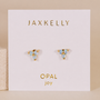 The Trio Cluster Gold Earrings - Fire Opal by JaxKelly feature three lab-grown fire opals on gold-plated settings, displayed on a white card labeled JAXKELLY at the top and OPAL joy in gold at the bottom.