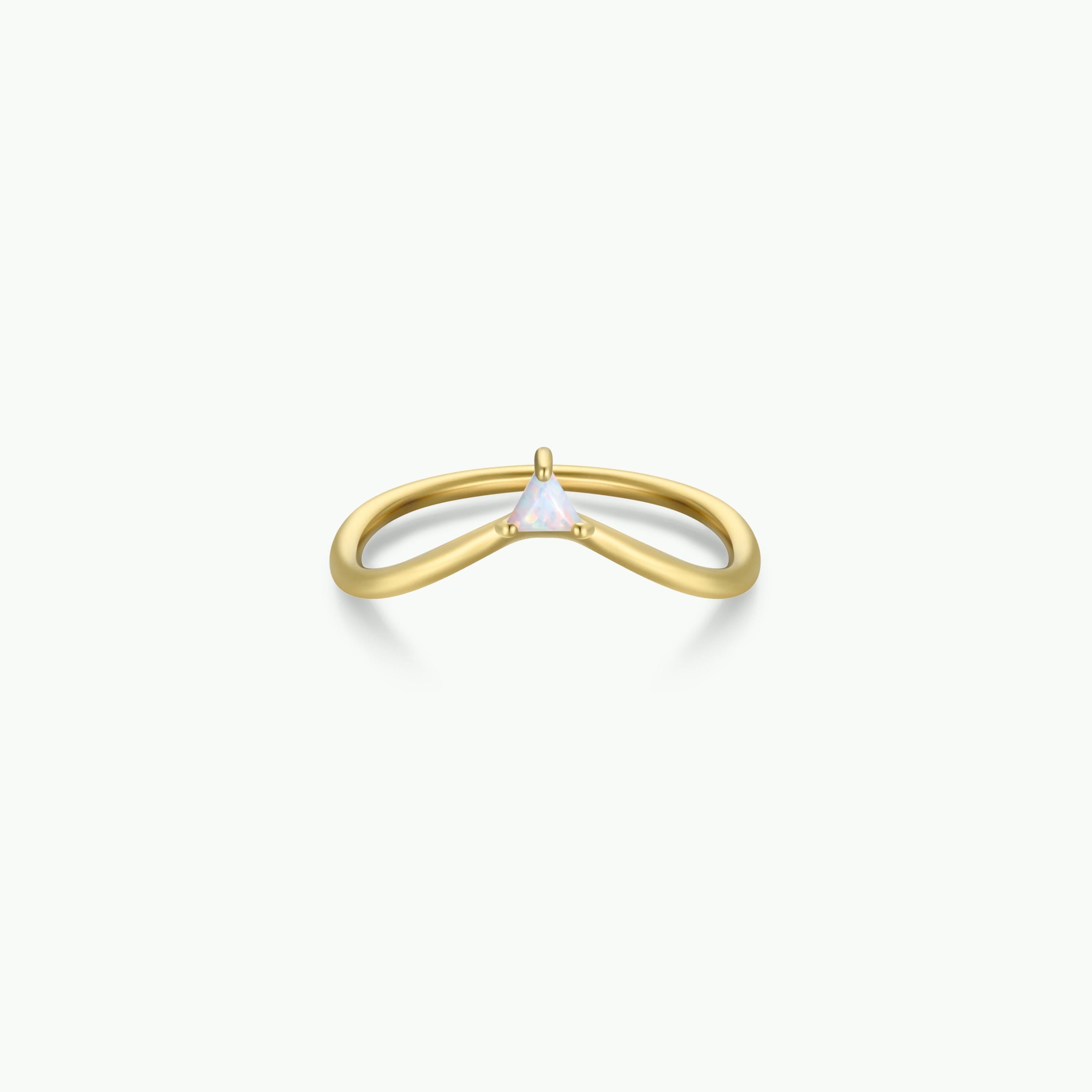 The Arched Triangle Ring - White Opal showcases a subtle V-shaped 18kt gold band and a small triangular white opal centerpiece—an elegant choice for lovers of heirloom-inspired jewelry. Displayed on a plain white background.
