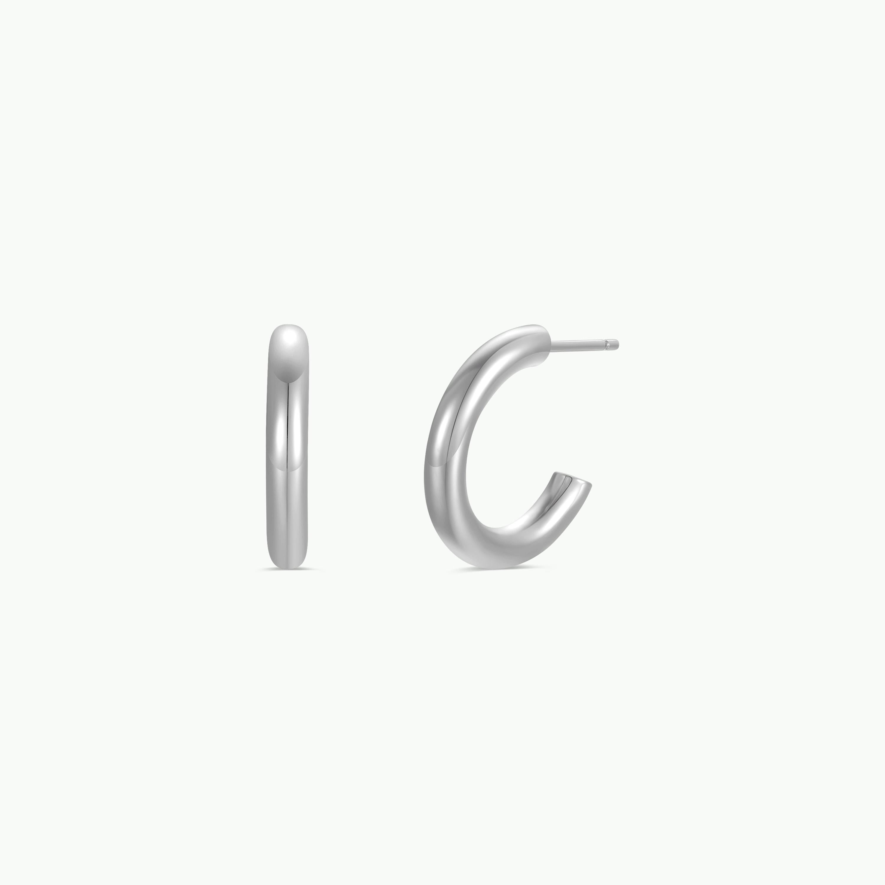 Two views of the JaxKelly Silver Hoop - Smooth earring are displayed against a plain white background: a side profile on the left and a front-facing angle on the right. The minimalist, polished design highlights expert craftsmanship, making this sterling silver hoop an elegant choice for any occasion.
