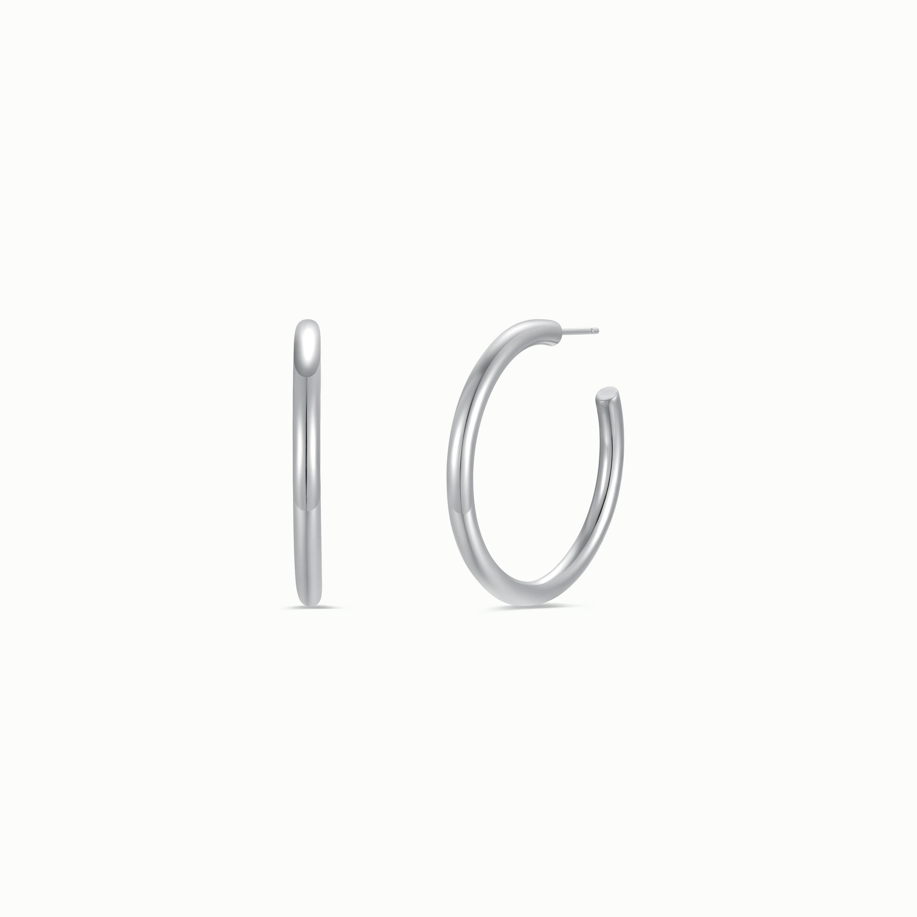 The Silver Everyday Hoop - Large is displayed on a white background, shown from side and front angles to highlight its polished sterling silver finish, circular shape, and timeless style.