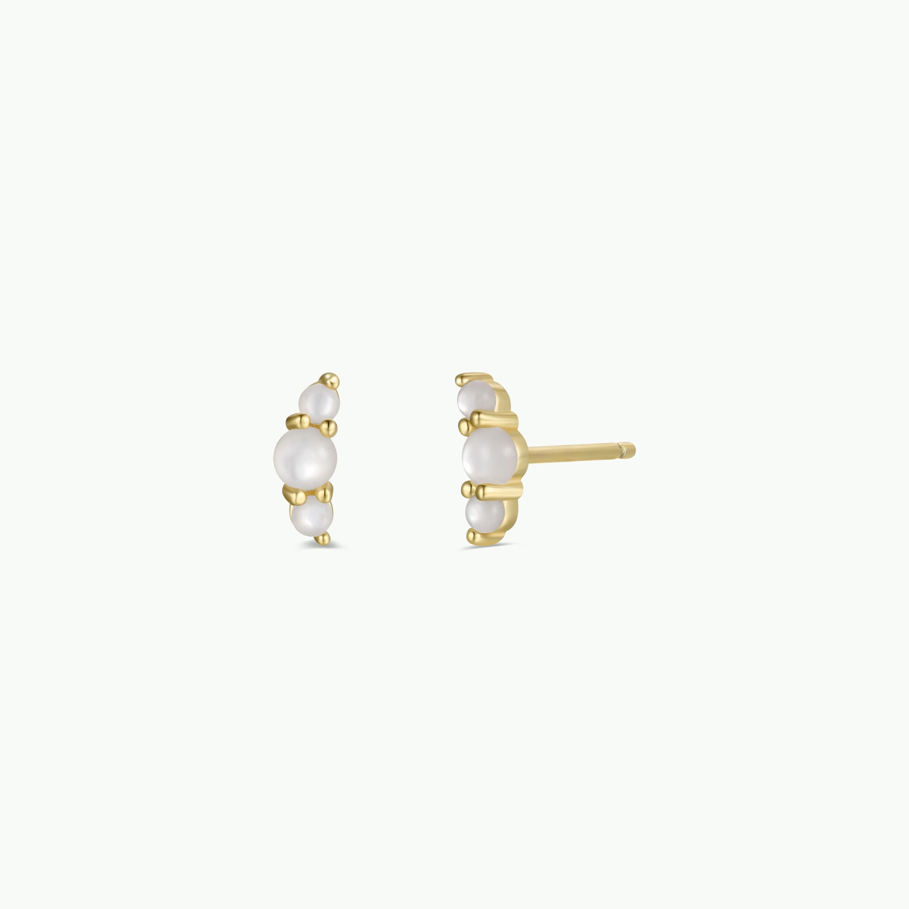 Crescent Gold Earrings - Pearl are gold plated stud earrings with a curved row of small white pearls and sterling silver posts, shown from side and front angles on a plain white background.