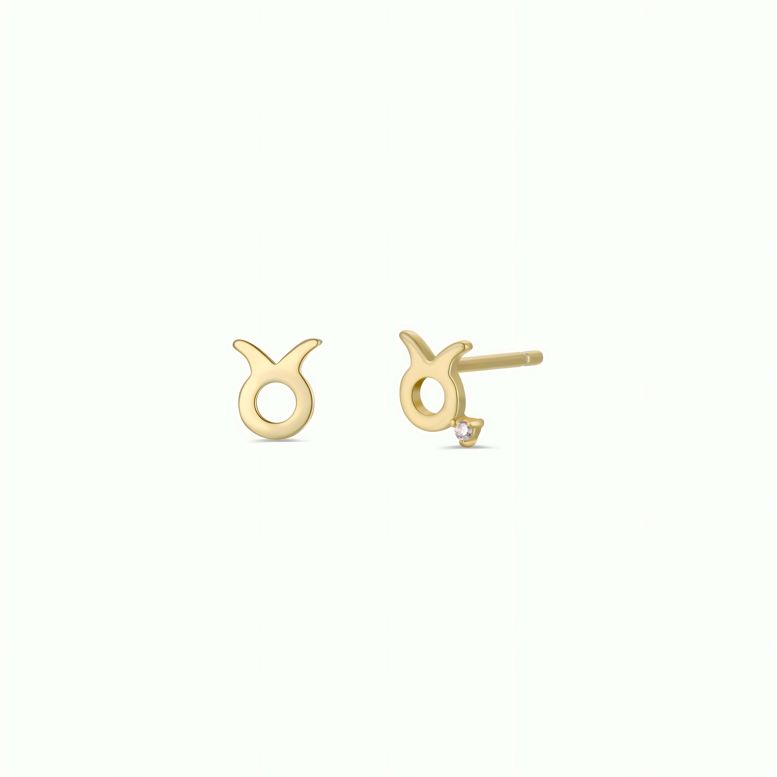A pair of Zodiac Earrings - Taurus in small gold plating, one displayed front and one side view on a light background—an ideal choice for zodiac jewelry enthusiasts.