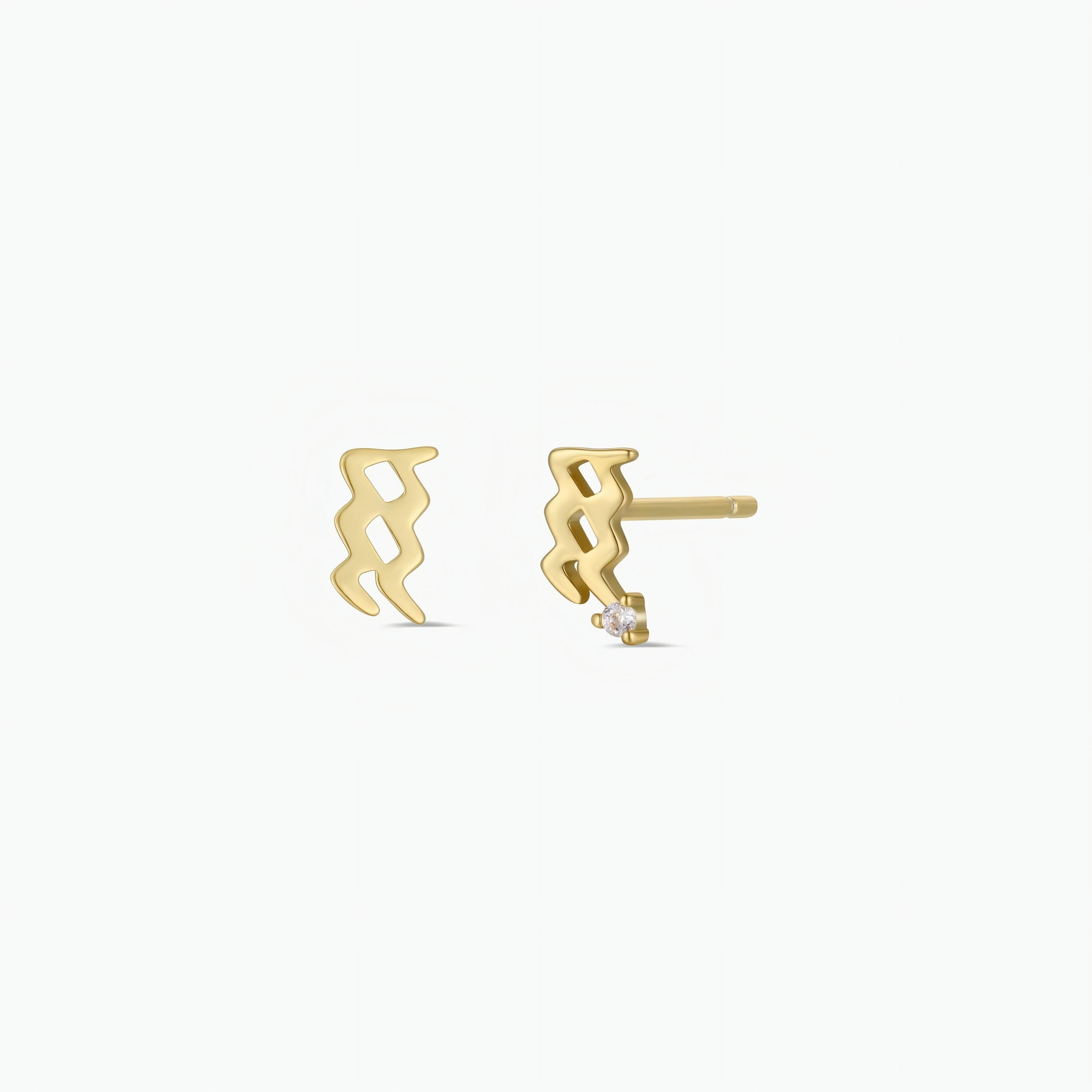 The Zodiac Earrings - Aquarius are small stud earrings shaped like the Aquarius symbol with 18k gold plating, ideal for ear piercings and displayed on a plain white background.